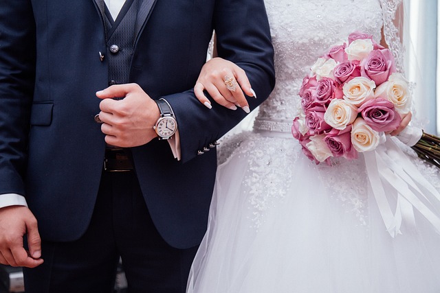 wedding couple linked arms with flower bouquet