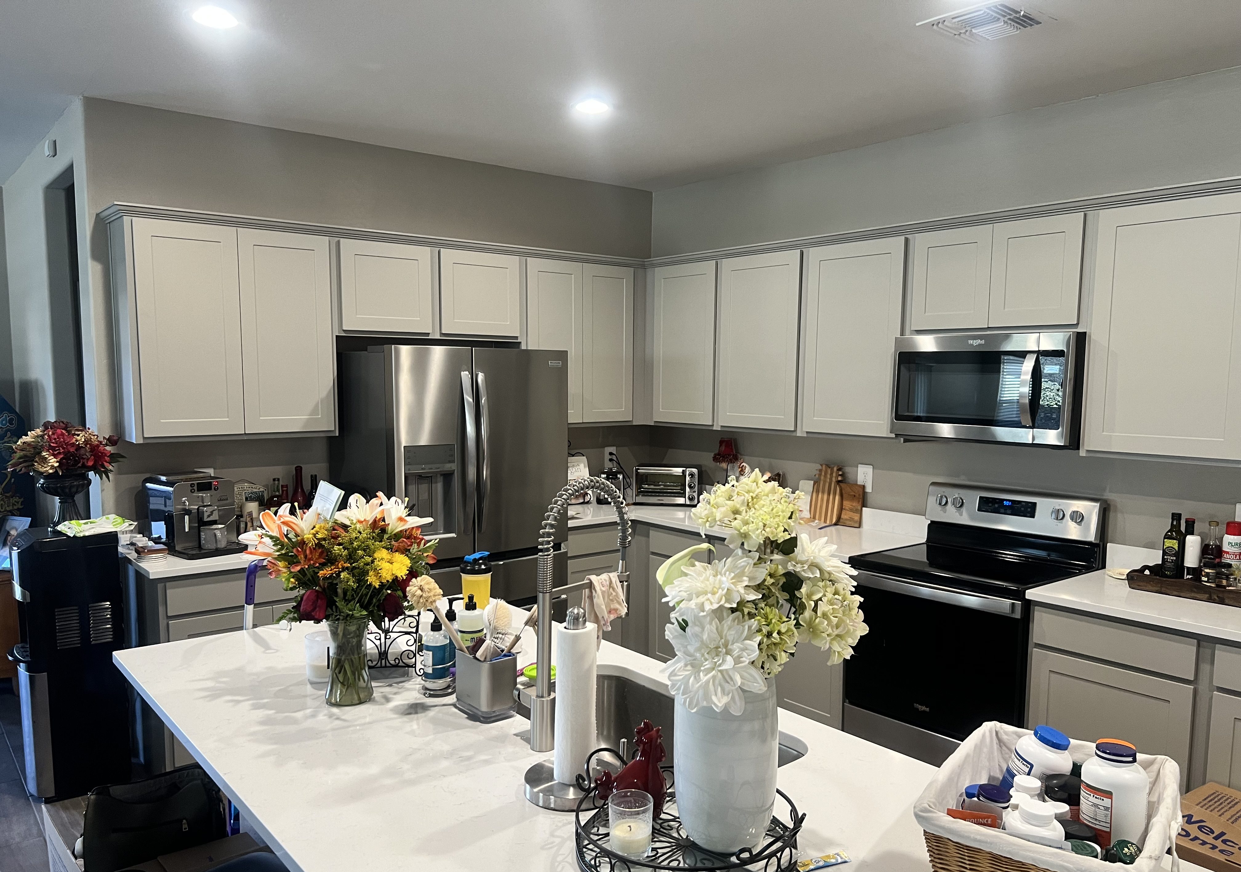 Kitchen cabinets with refrigerator and oven with stove and microwave